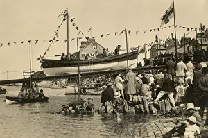 Swanage motor lifeboat Thomas Markby being launched down the slipway, crowds of people gathered on the shore Swanage motor lifeboat Thomas Markby being launched down the slipway, crowds of people gathered on the shore