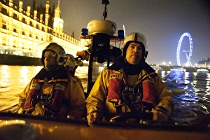 Tower lifeboat crew members on board an E-class lifeboat on the River Thames at night Tower lifeboat crew members on board an E-class lifeboat on the River Thames at night