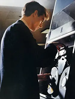 Vintage Computer Technology Prints: Adjusting a tape storage device