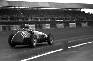 Alberto Ascari winning in a works Ferrari 500 at Stowe Corner - British Grand Prix Alberto Ascari winning in a works Ferrari 500 at Stowe Corner - British Grand Prix