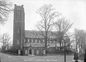 Prints of All Saints Church, R.C. Ballymena - a side view of the chapel with a man to the right. (Location: Northern Ireland: County Antrim). Date: circa early 1900s County Antrim Prints: Early 20th Century Print of All Saints Church, R.C. Ballymena