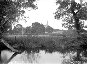 Prints of Armagh - a view over water to the city in the distance, only a Church spire and some buildings visible. (Location: Northern Ireland; County Armagh; Armagh). Date: circa early 1900s County Armagh Prints: Armagh Print - Early 20th Century Watercolour