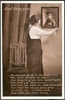 Print of a Young Woman Hanging a Photo on the Wall