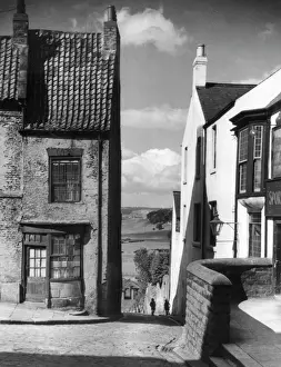 Prints of A quaint old shop front in a steep, cobbled corner of Bishop Auckland, County Durham, England. Date: 1950s Durham Prints: Bishop Auckland Quaint Shop Front Print, 1950s