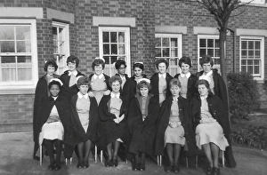 Black nurses amongst white nurses having a group picture Black nurses amongst white nurses having a group picture