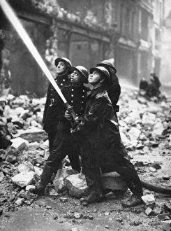 Blitz in London -- firefighters in action with hose, WW2 Blitz in London -- firefighters in action with hose, WW2