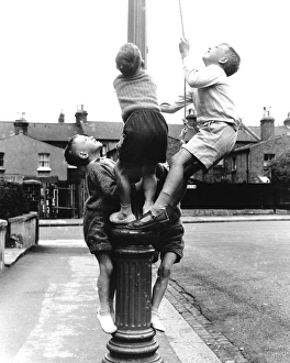 Boys on a lamp post on a Balham street, SW London Boys on a lamp post on a Balham street, SW London