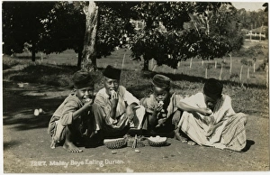 Boys in Malaysia eating Durian Fruit Boys in Malaysia eating Durian Fruit