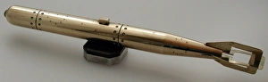 Brass model of torpedo sitting on bakelite and metal stand Brass model of torpedo sitting on bakelite and metal stand