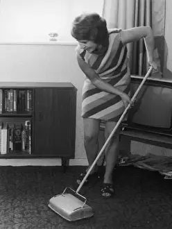 Prints of A young housewife using a carpet sweeper Sweeper Prints: Carpet Sweeper Print