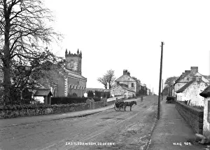 Prints of Castledawson, Co. Derry - a rural village street with church on the left and horse vehicle in the middle of the road. (Location: Northern Ireland: County Londonderry: Castledawson) Derry Prints: Castledawson, Co. Derry Print - Early 1900s