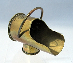 A coal-scuttle made from two types of shell cases A coal-scuttle made from two types of shell cases