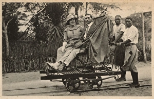 Couple riding trolley, Beira, Mozambique, East Africa Couple riding trolley, Beira, Mozambique, East Africa