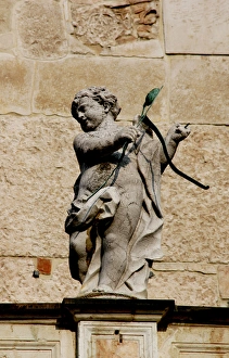 Cupid with bow and arrows. Sculpture. Facade of the Duomo in Cupid with bow and arrows. Sculpture. Facade of the Duomo in