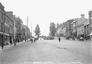 Prints of The Cut, Banbridge, Co. Down - a view up the Main street with shop fronts, motor vehicles and people. (Location: Northern Ireland; County Down; Banbridge). Date: circa early 1900s Down Prints: Early 20th Century Print of Banbridge Main Street