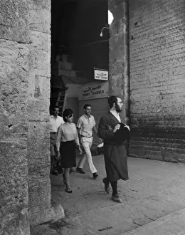 Damascus Gate Print: An Orthodox Jew leading a group through the gate