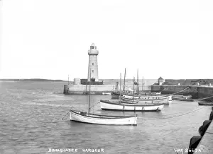 Prints of Donaghadee Harbour - a view of the boats pier and lighthouse, in the distance is the Copeland islands. (Location: Northern Ireland; County Down; Donaghadee). Date: circa early 1900s Monuments And Landmark Prints: Donaghadee Harbour Print - Early 1900s, Northern Ireland