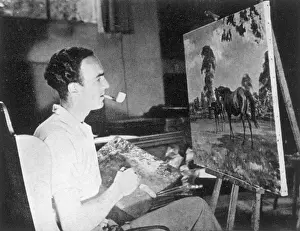 Prints of Mr. Edward Seago, the famous young artist, in his studio. Seago(1910-1974) is shown working on a painting of horses whilst smoking his pipe Herefordshire Prints: Edward Seago in his Studio Print: A Young Artist at Work