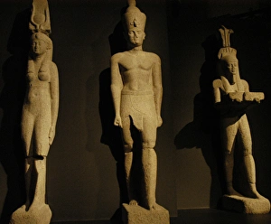 Egyptian art. Colossal statues of a pharaoh, his wife and th Egyptian art. Colossal statues of a pharaoh, his wife and th
