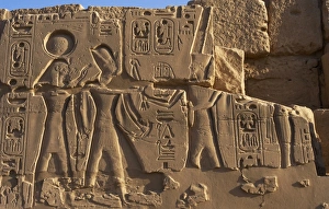 Egyptian Art. Karnak. The Pharaoh surrounded by two diviniti Egyptian Art. Karnak. The Pharaoh surrounded by two diviniti