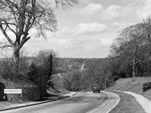 Prints of A solitary vehicle leaving Rickmansworth, Hertfordshire, England, in the days when it was more like a country lane. Date: 1950s Hertfordshire Prints: Vintage Print of Rickmansworth, Hertfordshire, England 1950s