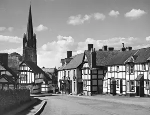 Prints of Weobley, a beautiful Herefordshire market town of old half-timbered houses, mellowed by age and clustering round an imposing 14th century church. Date: 1950s Herefordshire Prints: Weobley, Herefordshire Market Town Print, 1950s