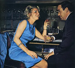 London 1960s Fashion Prints: Escort sharing a drink with a client