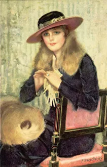 Fashionably dressed lady in hat sits waiting in a chair Date: 1910 Fashionably dressed lady in hat sits waiting in a chair Date: 1910