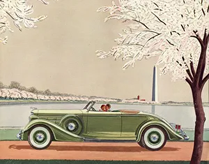 A fine green open-top convertible 1920s sports car passes the Washington Monument A fine green open-top convertible 1920s sports car passes the Washington Monument