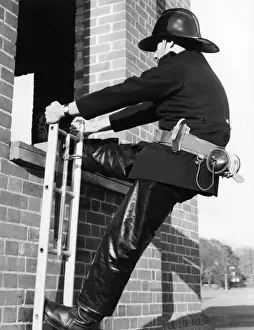 Prints of Firefighter during hook ladder practice. Date: 1967 Cercopithecidae Prints: Firefighter during Hook Ladder Practice Print, 1967