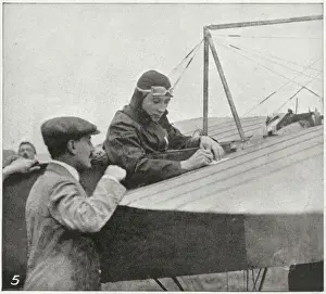 Prints of A plane as a blotting-pad: Mr Gustave Hamel writes a few notes before taking off on the first aerial post in England Aviation Prints: The First Aerial Post in England Print