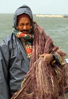 A fisherman wearing oilskins. Djerba, Tunisia A fisherman wearing oilskins. Djerba, Tunisia