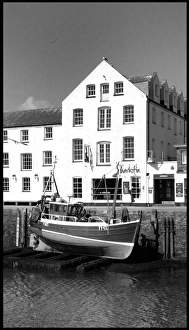 Fishing boat lifted Mevagissey harbour, Cornwall Fishing boat lifted Mevagissey harbour, Cornwall
