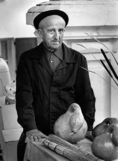Frenchman with large gourd in a market in Montaigu-de-Quercy Frenchman with large gourd in a market in Montaigu-de-Quercy