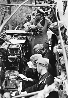 Prints of General Heinz Guderian in his armoured half-track command vehicle. To the lower left of the picture is his Enigma coding machine. Date: 1941 Generals And Leader Prints: General Guderian with Enigma Machine Print, 1941