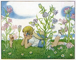 Girl with a baby fairy lying in the garden in summer Girl with a baby fairy lying in the garden in summer
