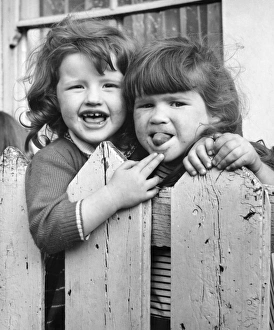 Two girls behind a fence, Balham, SW London Two girls behind a fence, Balham, SW London
