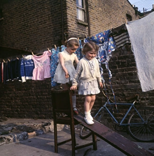Two girls playing on planks, Balham, SW London Two girls playing on planks, Balham, SW London