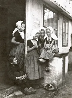 A group of Dutch fisherchildren, four girls and a boy, wearing traditional costumes A group of Dutch fisherchildren, four girls and a boy, wearing traditional costumes