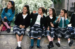 A group of happy schoolgirls wearing Spanish tartan skirts A group of happy schoolgirls wearing Spanish tartan skirts