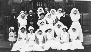 Group of nurses, older ladies, cleric and little girl Group of nurses, older ladies, cleric and little girl