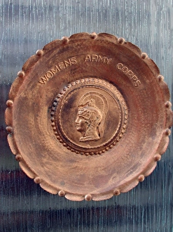 A handmade metal plate, stamped Womens Army Corps A handmade metal plate, stamped Womens Army Corps