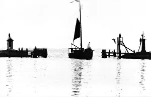 Harbour with sailing boat and religious statue Harbour with sailing boat and religious statue