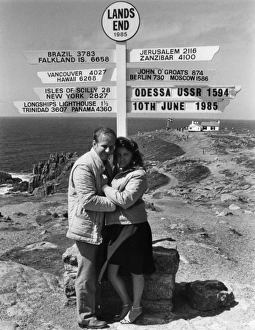 Honeymoon couple and signpost at Lands End, Cornwall Honeymoon couple and signpost at Lands End, Cornwall