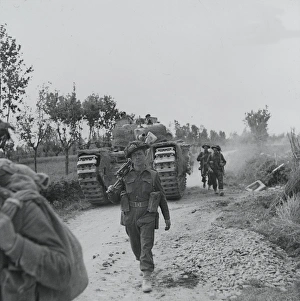 Infantry and supporting tanks advancing along the Argenta ro Infantry and supporting tanks advancing along the Argenta ro