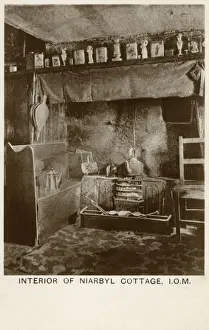 Prints of View of the interior of a traditional cottage at Niarbyl, on the south west coast of the Isle of Man. A kettle sits on the open coal fire, and a pair of bellows hang from a hook on the left Isle Of Man Prints: Traditional Isle of Man Cottage Interior Print circa 1950