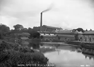 Prints of Island Spinning Mill, Lisburn - a scenic view across the river to the spinning mill. There are barges on the water. (Location: Northern Ireland: County Antrim: Lisburn). Date: circa early 1900s River Prints: Early 20th Century Print of Lisburn Island Spinning Mill