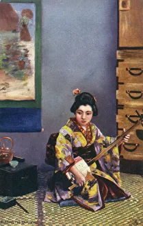 Japanese Geisha playing a Traditional Shamisen Japanese Geisha playing a Traditional Shamisen