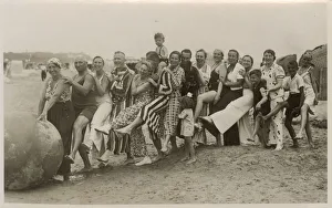 A very jolly group playing with a huge ball on the beach A very jolly group playing with a huge ball on the beach