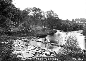 Prints of Kells Water at the Stepping Stones - a view of the river with two girls standing on the stepping stones. (Location: Northern Ireland; County Antrim; Kells td.). Date: circa early 1900s River Prints: Early 20th Century Print of Kells Water Stepping Stones